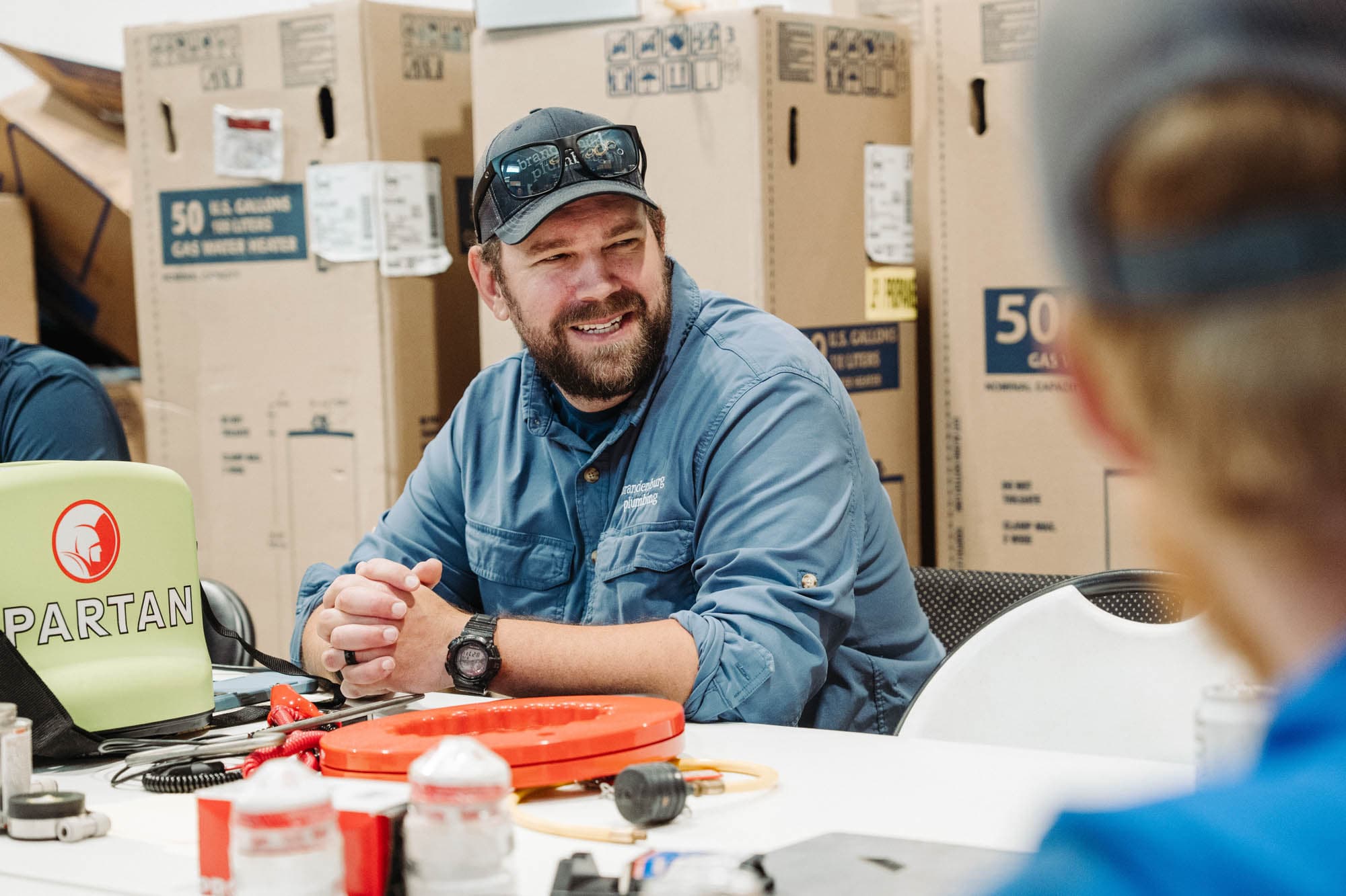 A Brandenburg repair team member listening during a planning conversation.